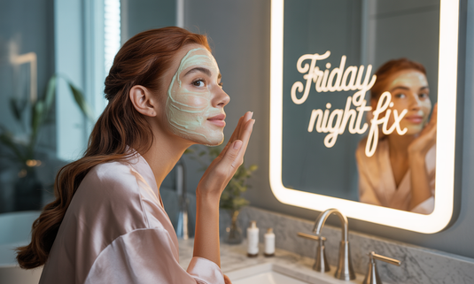 A woman with glowing, radiant skin applying Glamacious Bakuchiol Timeless Sleep Mask before stepping out on Friday night