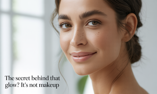 Smiling woman with naturally glowing skin, no makeup look