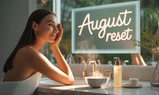 Woman applying skincare in front of mirror - August skincare reset concept